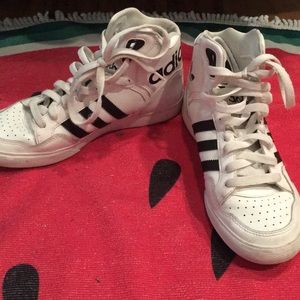 Black and white adidas high top sneakers.
